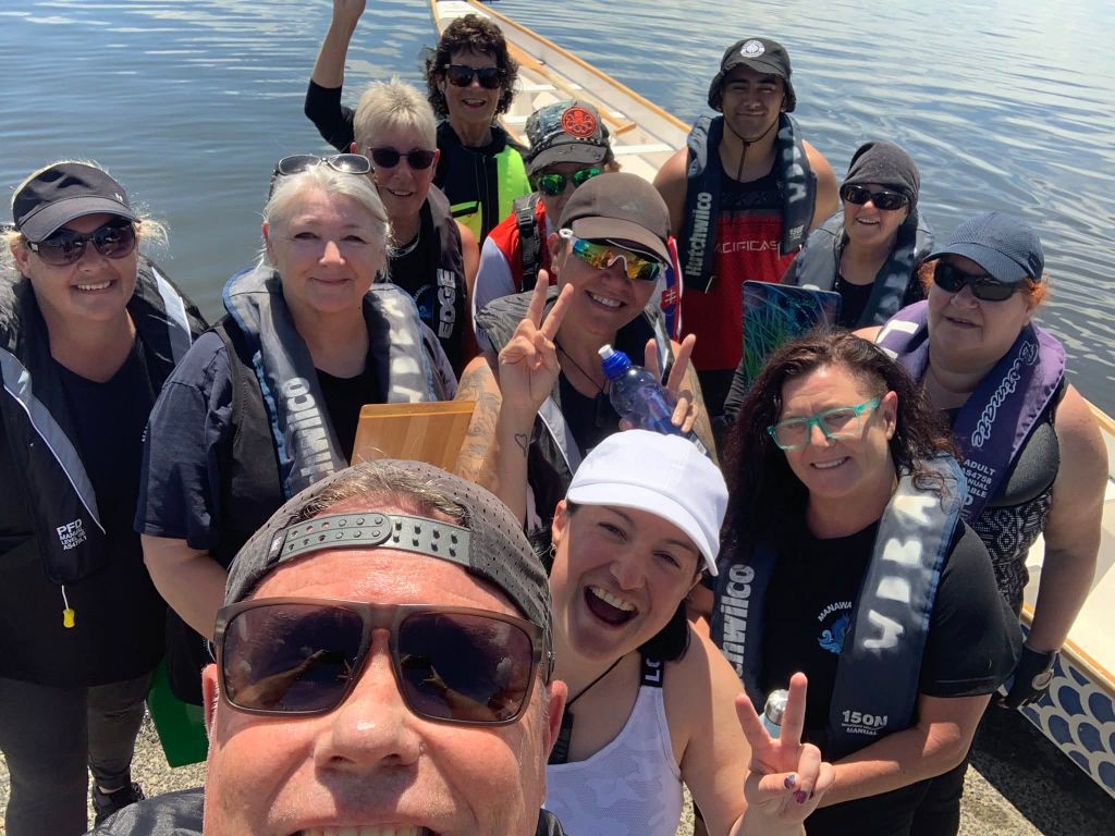 Team at regatta with paddles